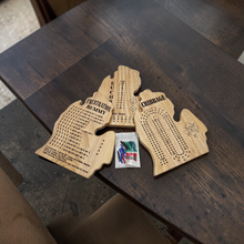Load image into Gallery viewer, Wooden game boards Frustration rummy, Euchre, Cribbage on dark wooden surface with small bag of plastic marking pegs.